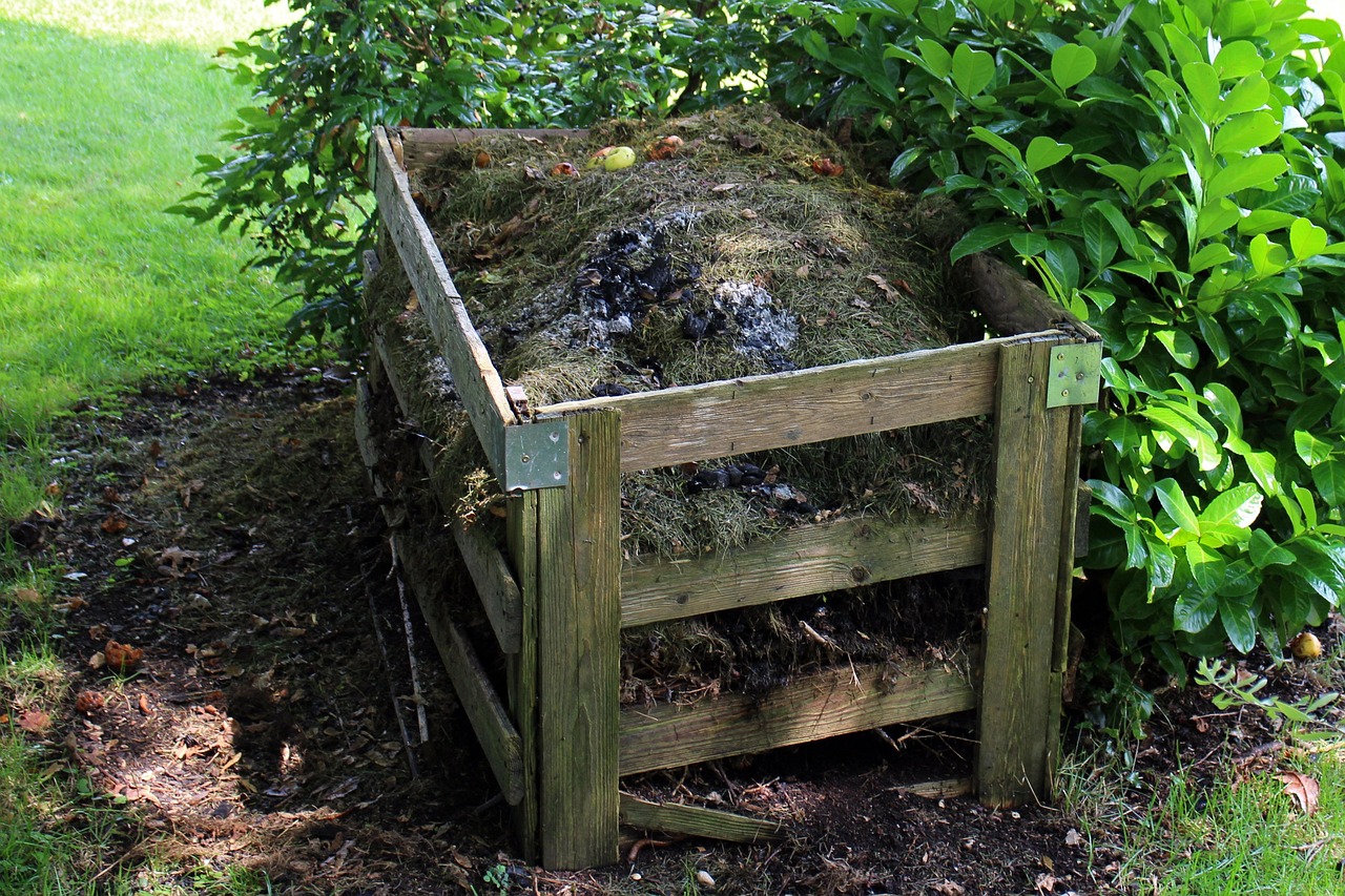 Compost in un contenitore con materiali organici, con un avviso su pratiche da evitare per un terreno fertile.